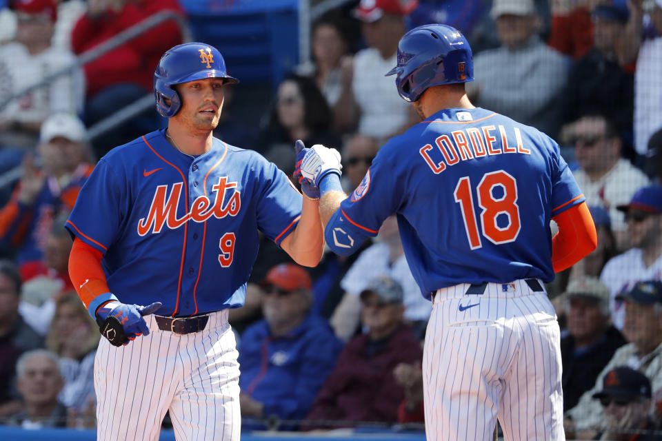 New York Mets' Brandon Nimmo (9) is congratulated by teammate Ryan Cordell (18) after scoring during the first inning of a spring training baseball game against the St. Louis Cardinals Friday, Feb. 28, 2020, in Port St. Lucie, Fla. (AP Photo/Jeff Roberson)