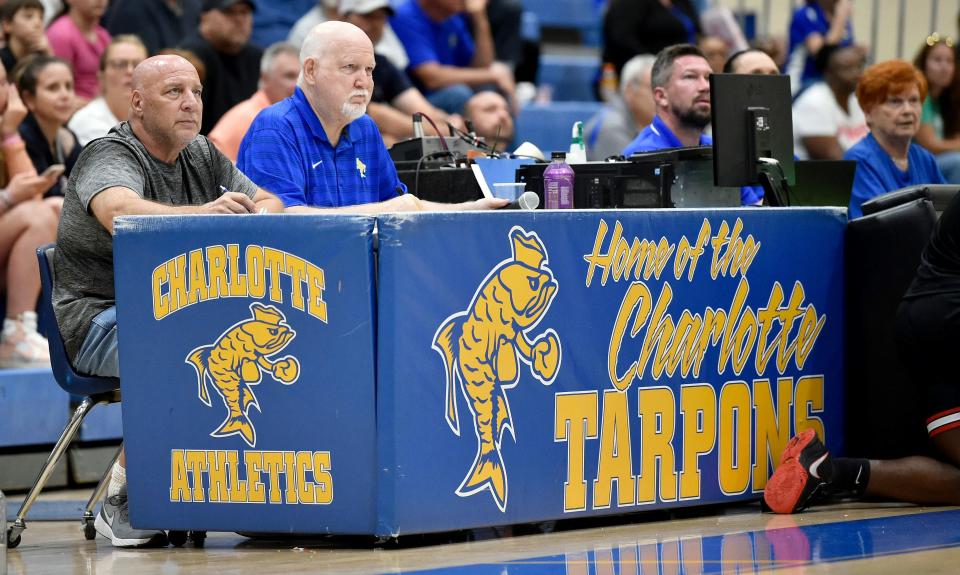 Dennis Maffezzoli, left, sits at the scorers' table at Charlotte High's Wally Keller Gymnasium for a boys regional basketball game between Palmetto High and Charlotte High.