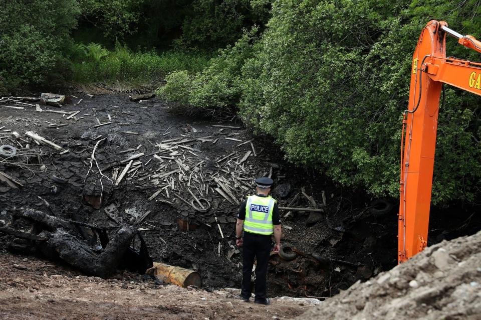 A Police officer at the emptied Leanach Quarry which is being searched as part of the investigation into the 40-year-old mystery. (PA)