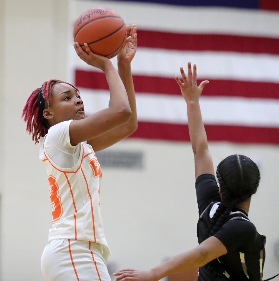 Ellet's Sanaiiya Gray shoots over a Buchtel player during the first half of a high school basketball game, Wednesday, Jan. 31, 2024, in Akron, Ohio.