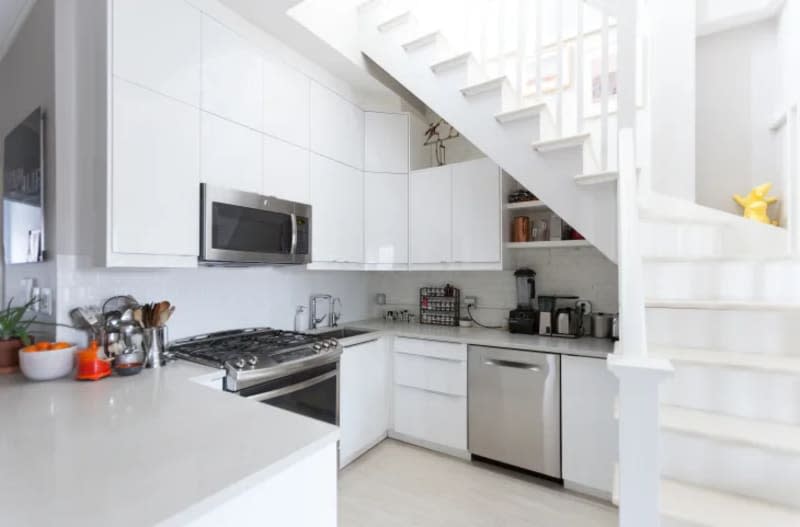 a white kitchen with light gray countertops