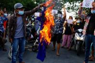 FILE PHOTO: Protesters against Myanmar's junta burn the flag of the Association of Southeast Asian Nations (ASEAN), in Mandalay