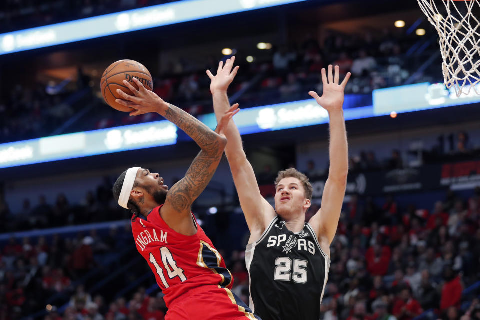 New Orleans Pelicans forward Brandon Ingram (14) shoots against San Antonio Spurs center Jakob Poeltl (25) in the first half of an NBA basketball game in New Orleans, Wednesday, Jan. 22, 2020. (AP Photo/Gerald Herbert)