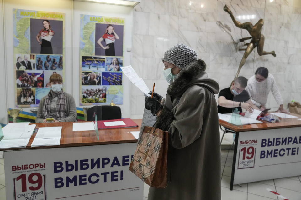 A woman prepares to cast her ballot at a polling station during a parliamentary elections in Moscow, Russia, Friday, Sept. 17, 2021. Russia has begun three days of voting for a new parliament that is unlikely to change the country's political complexion. There's no expectation that United Russia, the party devoted to President Vladimir Putin, will lose its dominance in the State Duma. (AP Photo/Pavel Golovkin)