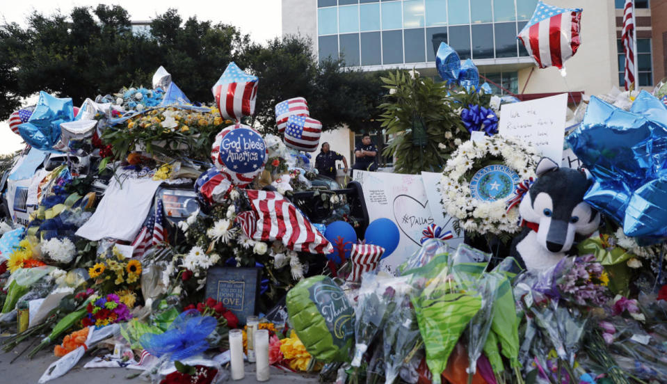 Dallas police officers keep watch over a makeshift memorial