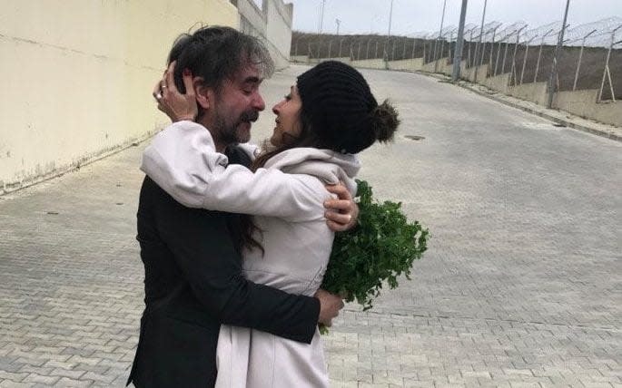 Deniz Yucel hugs his wife, Dilek Mayatuerk, after being released from prison in Istanbul - REUTERS