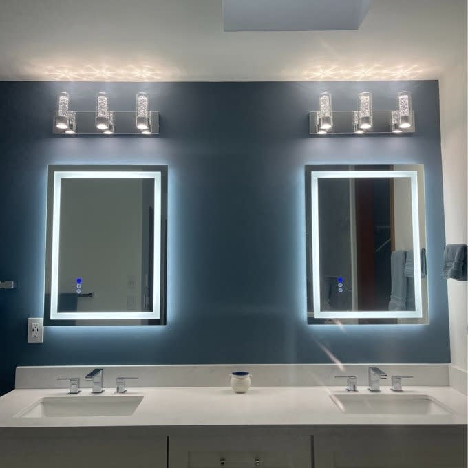 two of the LED mirrors in a reviewer's bathroom