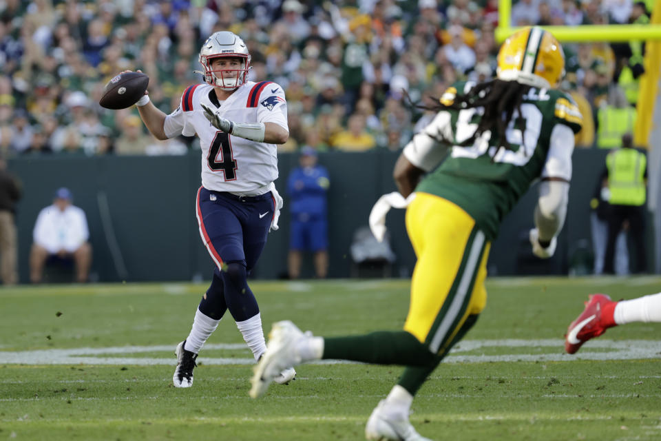 New England Patriots quarterback Bailey Zappe (4) threw his first career touchdown after officials missed calling a penalty. (AP Photo/Mike Roemer)