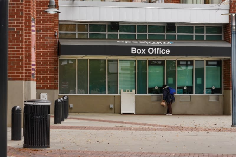 Mar 13, 2020; Charlotte, North Carolina, USA; A curious fan peers into the closed box office at the Spectrum Center in Charlotte after the game between the Cleveland Cavaliers and Charlotte Hornets was cancelled due to the Corona Virus