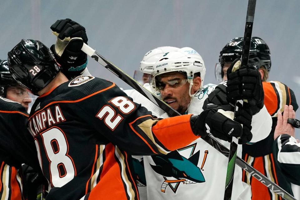 San Jose Sharks left wing Evander Kane, right, scuffles with Anaheim Ducks defenseman Jani Hakanpaa during the first period of an NHL hockey game Saturday, March 13, 2021, in Anaheim, Calif. (AP Photo/Mark J. Terrill)