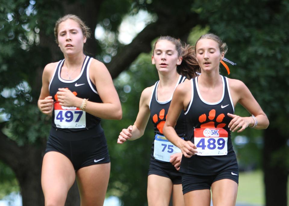 Brighton's (from left) Carrigan Eberly, Lydia LaMarra and Elle Bissett have three of the top five girls cross country times in Livingston County.