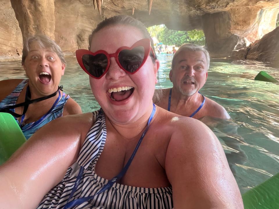 megan and her family posing for a selfie in the water at discover cove in orlando florida