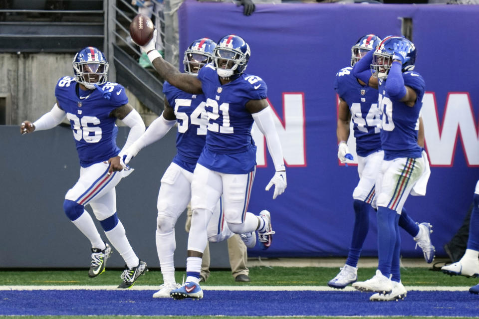 New York Giants' Landon Collins (21) celebrates with teammates after returning an interception for a touchdown during the first half of an NFL football game against the Indianapolis Colts, Sunday, Jan. 1, 2023, in East Rutherford, N.J. (AP Photo/Seth Wenig)