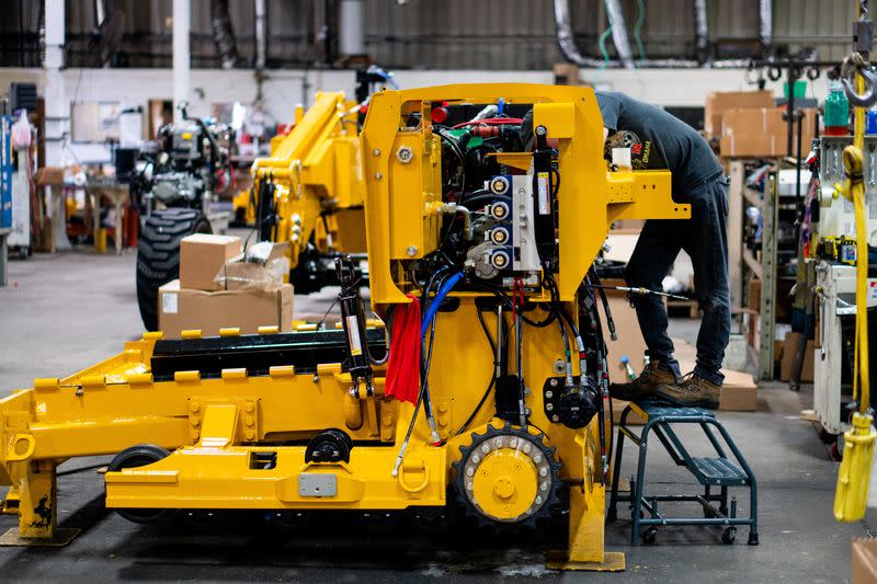 William Vasquez assembles a paving machine at the Calder Brothers factory, in Taylors