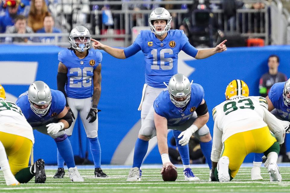 Detroit Lions quarterback Jared Goff stands at the line of scrimmage and talks to teammates before a play against the Green Bay Packers during the first half at Ford Field in Detroit on Thursday, Nov. 23, 2023.