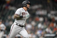 Arizona Diamondbacks' David Peralta runs down the first base line after hitting an RBI single against the Houston Astros during the 10th inning of a baseball game Friday, Sept. 17, 2021, in Houston. (AP Photo/David J. Phillip)