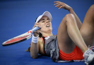 France's Alize Cornet reacts after falling during her second round match against United States' Venus Williams at the Australian Open tennis championships in Melbourne, Australia, Thursday, Jan. 17, 2019. (AP Photo/Andy Brownbill)