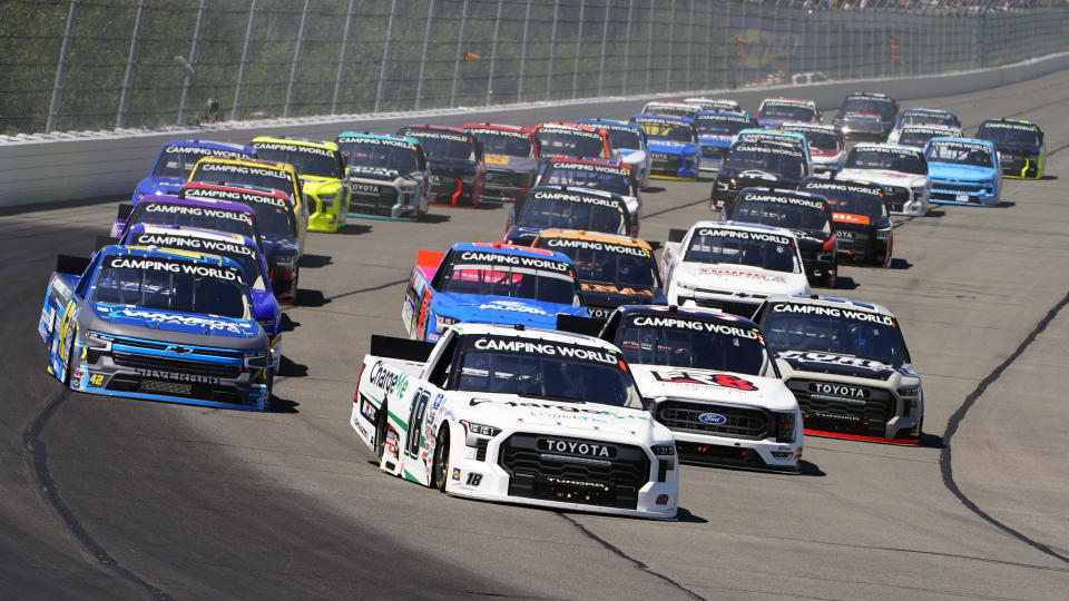 Chandler Smith (18) leads the pack down the front straight on a restart of the NASCAR Truck Series auto race at Pocono Raceway, Saturday, July 23, 2022 in Long Pond, Pa. (AP Photo/Matt Slocum)