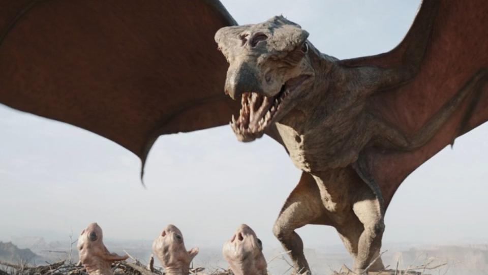 A giant wyvern-like creature roars with her wings wide over her three babies in a nest on The Mandalorian