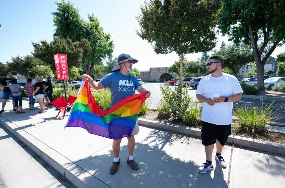 Tom Crain, left, shows his support for the LGBTQ+ community as he talks with David C., a member of First Church in Ripon, outside the Salida library during it’s Rainbow Story time at the Stanislaus County Library in Salida, Calif., Thursday, June 15, 2023. Andy Alfaro/aalfaro@modbee.com