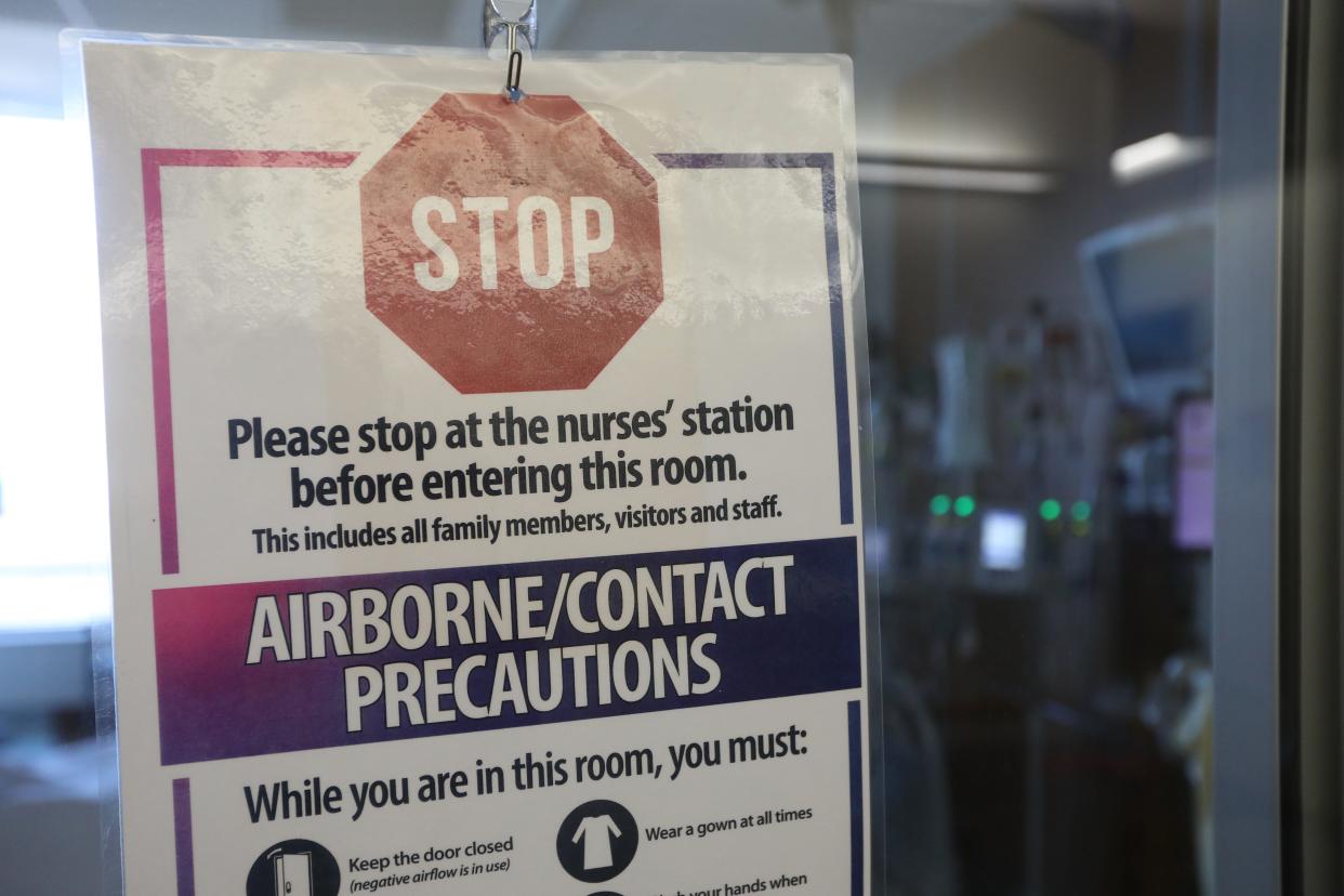 This a sign that hung on a door of a patient's room in the Genesis Hospital Critical Care Unit during the COVID-19 pandemic.