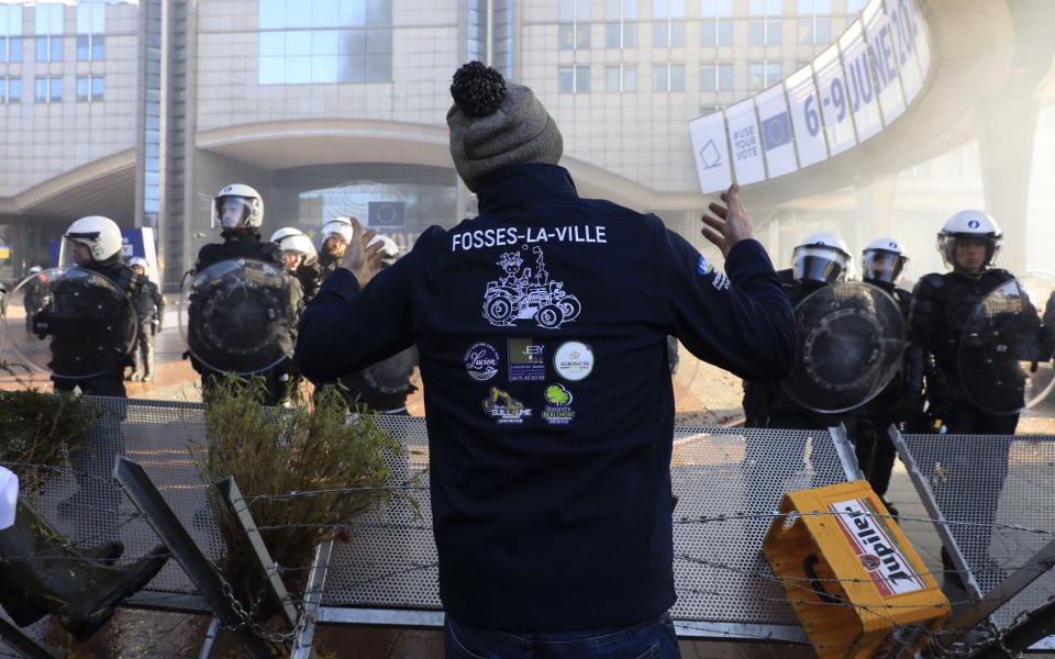 A demonstrator shouts slogans near the European parliament during the farmer protest