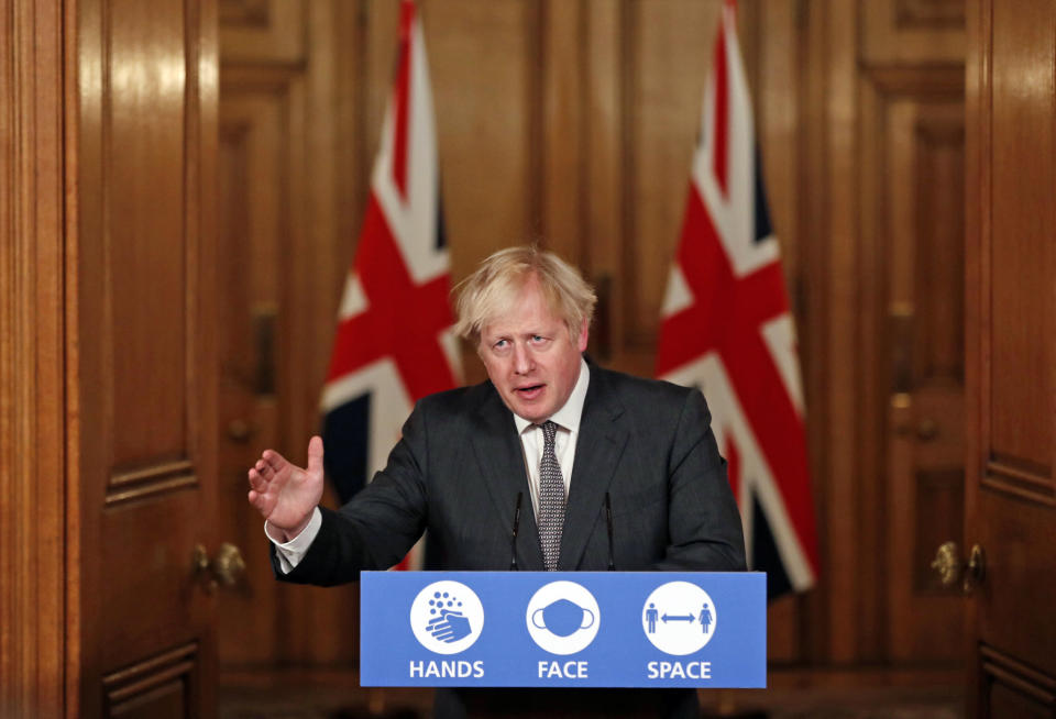 FILE - In this Wednesday Dec. 30, 2020 file photo, Britain's Prime Minister Boris Johnson speaks at a press conference in 10 Downing Street, London. Johnson has warned that more onerous lockdown restrictions in England are likely as the country reels from a new variant of the coronavirus that has seen infection rates soar to their highest recorded levels. The U.K. is in the midst of an acute outbreak, recording more than 50,000 new coronavirus infections a day over the past five days. (Heathcliff O'Malley/Pool via AP)