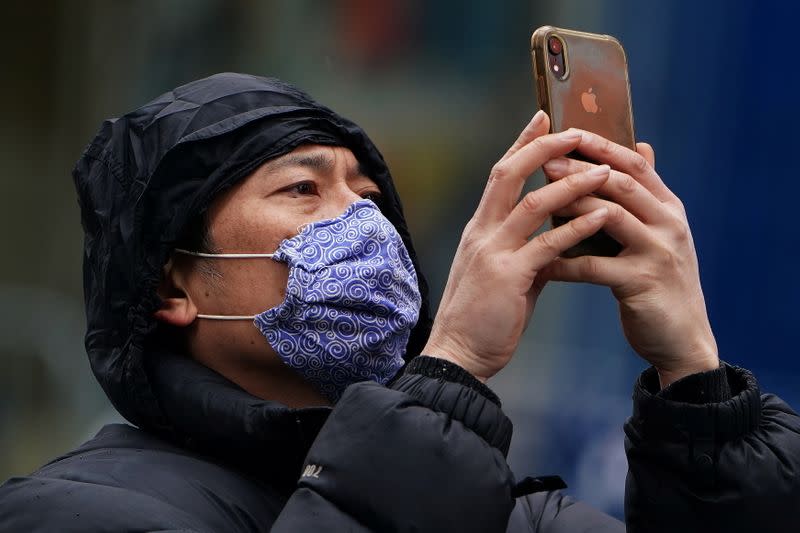 A man takes a photo in Times Square ahead of New Year's Eve