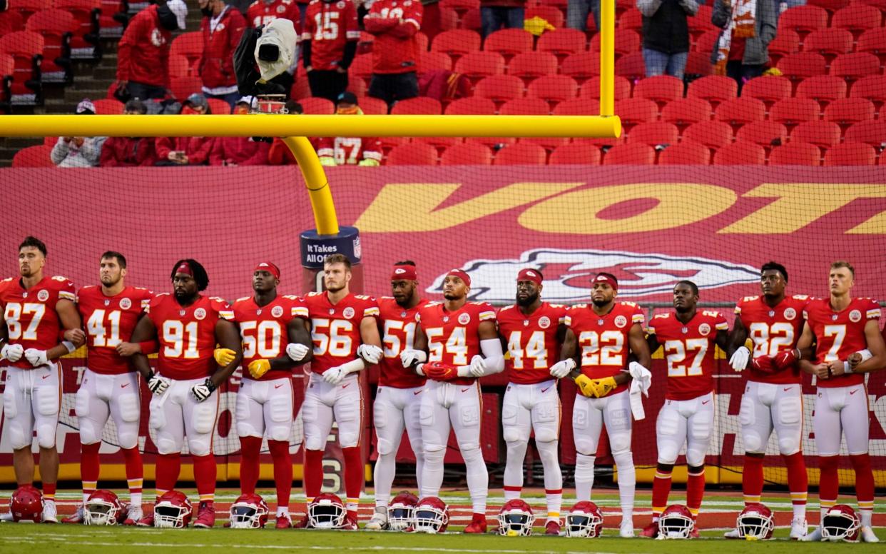 Fans jeer as NFL teams come together for 'moment of unity' in fight for equality -  AP