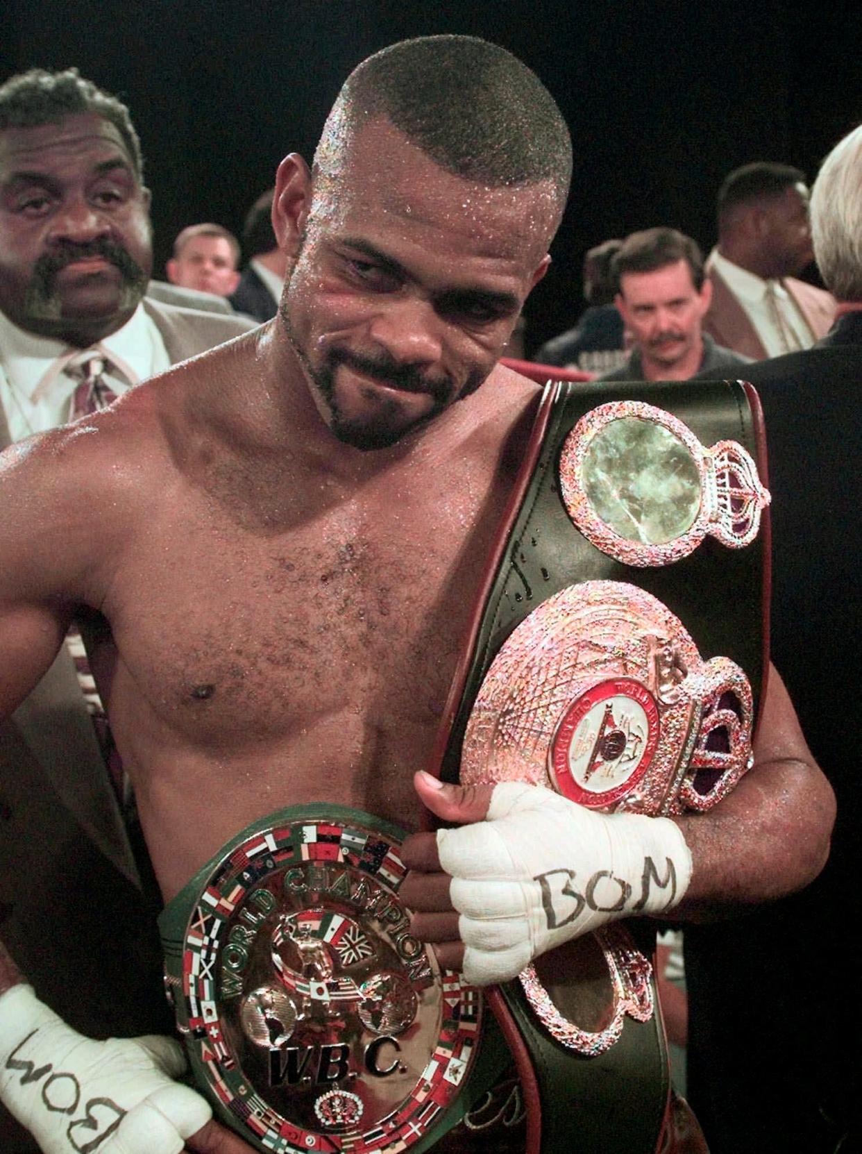 FILE - World Boxing Commission light heavyweight champion Roy Jones, Jr. holds onto two belts after winning a unification bout with World Boxing Association light heavyweight champion Lou Del Valle at Madison Square Garden in New York, Saturday, July 18, 1998. Jones won a clear-cut unanimous 12-round decision. Roy Jones Jr. was inducted into the Boxing Hall of Fame in Canastota, N.Y., on Sunday, June 12, 2022.