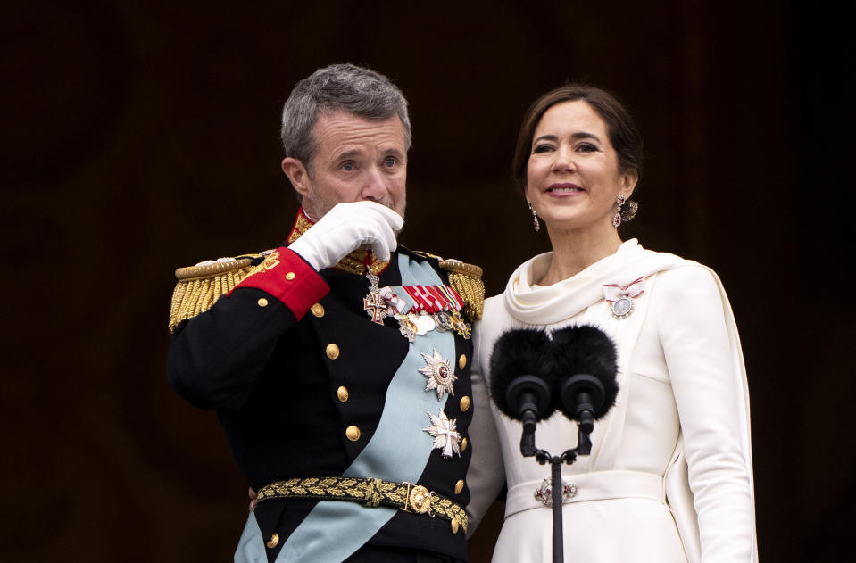 Denmark's King Frederik X gestures as he and Queen Mary greet the crowds on the balcony, after the proclamation, at Christiansborg Palace, in Copenhagen, Sunday, Jan. 14, 2024. Denmark’s prime minister proclaimed Frederik X as king after his mother Queen Margrethe II formally signed her abdication. Massive crowds turned out to rejoice in the throne passing from a beloved monarch to her popular son. (Bo Amstrup/Ritzau Scanpix via AP)