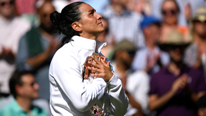 Tunisian tennis player Ons Jabeur hugging the runners-up trophy at Wimbledon, London, the UK - Saturday 9 July 2022