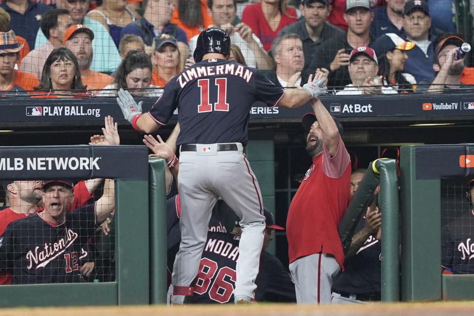 Washington Nationals' Ryan Zimmerman is congratulated after hitting a home run during the second inning of Game 1 of the baseball World Series against the Houston Astros Tuesday, Oct. 22, 2019, in Houston. (AP Photo/David J. Phillip)