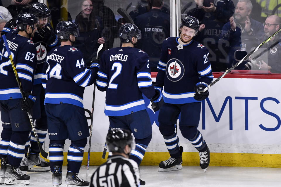 Winnipeg Jets' Mason Appleton celebrates his goal against the San Jose Sharks with Dylan Demelo (2) and Josh Morrissey (44) during the third period of an NHL hockey game in Winnipeg, Manitoba, on Monday April 10, 2023. (Fred Greenslade/The Canadian Press via AP)