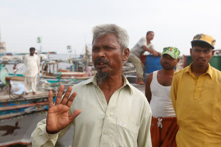 Fisherman Noor Mohammad, a Rohingya immigrant living in Pakistan, gestures during an interview with Reuters at the fish harbour in Ibrahim Hydri in Karachi, Pakistan September 7, 2017. Picture taken September 7, 2017. REUTERS/Akhtar Soomro