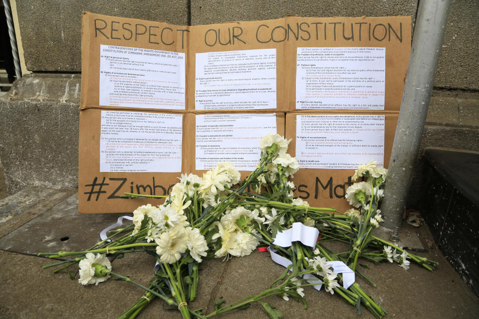 Flowers are placed outside the High Court during a peaceful protest by Zimbabwe lawyers over abuse of power by the courts in Harare, Wednesday Sept, 2, 2020. Human rights defenders say it appears the government is using restrictions imposed to combat COVID-19 to suppress political criticism. Opposition officials, human rights groups and some analysts accuse Mnangagwa of abusing the rights of critics, using tactics as harsh as his predecessor, the late Robert Mugabe. (AP Photo/Tsvangirayi Mukwazhi)