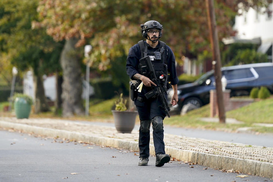 A law enforcement officer patrols a street near the scene where two officers wounded in a shooting, Tuesday, Nov. 1, 2022, in Newark, N.J. Two officers were being treated for injuries at a nearby hospital, according to the Essex County prosecutor's office. (AP Photo/Seth Wenig)