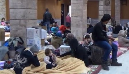 A still image taken from a video obtained by Reuters, said to be shot on January 4, 2017, shows civilians, who were evacuated from Wadi Barada, sitting inside a shelter in the Damascus suburb of Rawda, Syria. REUTERS TV/via REUTERS