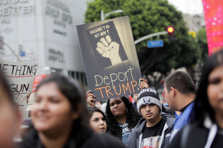 A person holds up a sign saying "Deport TRUMP!" during a May Day rally in Los Angeles, California, U.S., May 1, 2018. REUTERS/Jenna Schoenefeld