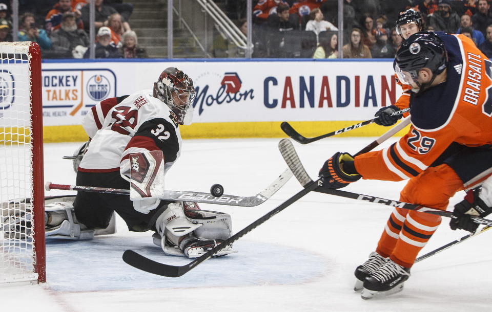 Arizona Coyotes goalie Antti Raanta (32) makes a save on Edmonton Oilers' Leon Draisaitl (29) during second period NHL action in Edmonton, Alberta, on Saturday, Jan. 18, 2020. (Jason Franson/The Canadian Press via AP)