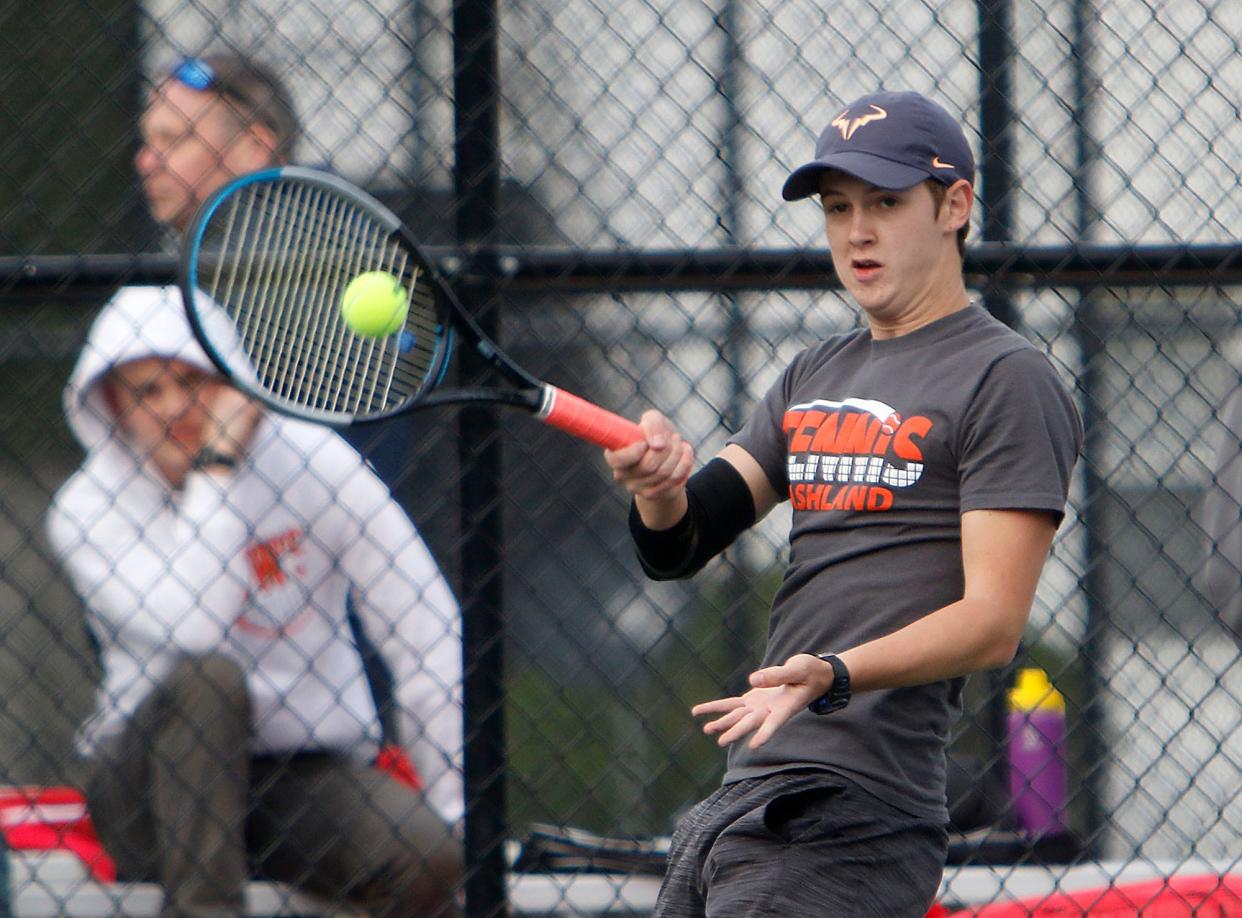 Ashland's Cooper Glazier returns a shot during his first singles match against Mount Vernon Thursday, April 28, 2022 at Brookside Park.