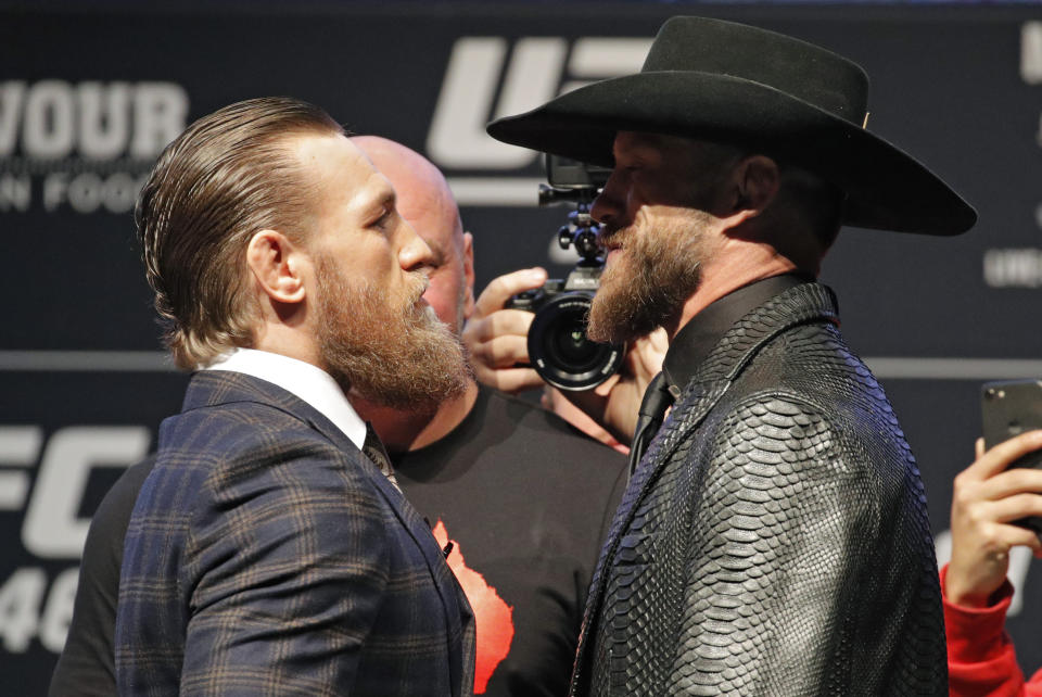 Conor McGregor, left, and Donald "Cowboy" Cerrone pose for photographers during a news conference for a UFC 246 mixed martial arts bout, Wednesday, Jan. 15, 2020, in Las Vegas. The two are scheduled to fight in a welterweight bout Saturday. (AP Photo/John Locher)
