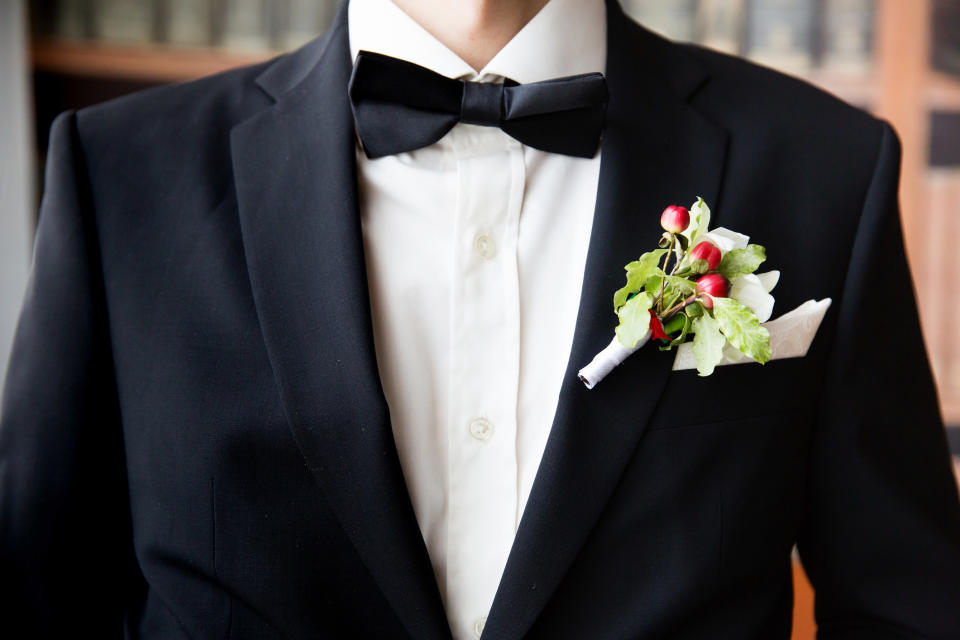 A person in a bow tie with a corsage