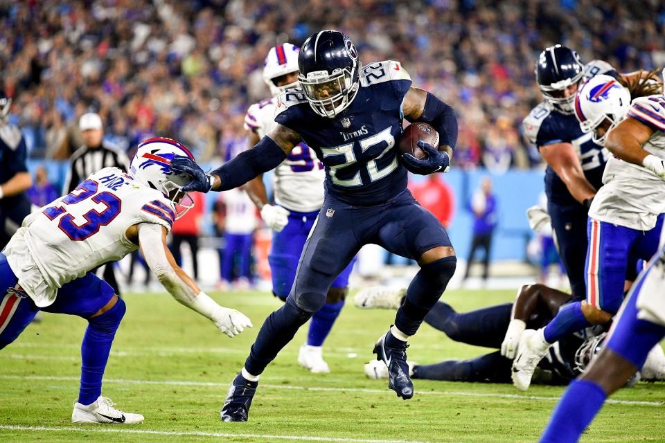 Tennessee Titans running back Derrick Henry (22) keeps Buffalo Bills safety Micah Hyde (23) at arms length as he runs for a touchdown at Nissan Stadium Monday, Oct. 18, 2021 in Nashville, Tenn. 