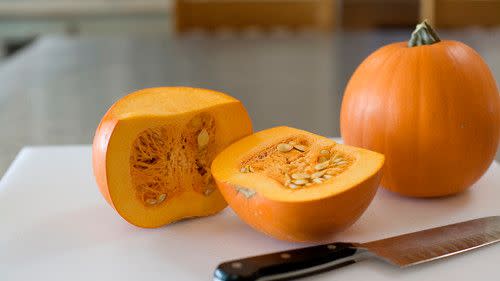 Pumpkin on cutting board with knife