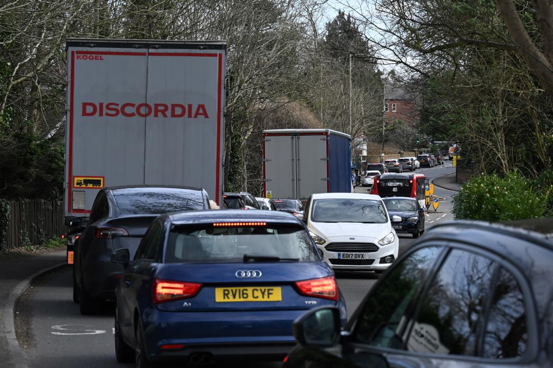 Vehicles queue along the street going into Weybridge south-west of London on March 16, 2024, as the London orbital motorway M25 sees it's first total closure over a weekend since it's opening in 1986. The M25 will be closed between junctions 10 and 11 from Friday 15 March 2024 evening until Monday 18 March 2024 morning to demolish the Clearmount bridleway bridge and install a very large gantry. (Photo by JUSTIN TALLIS / AFP) (Photo by JUSTIN TALLIS/AFP via Getty Images)