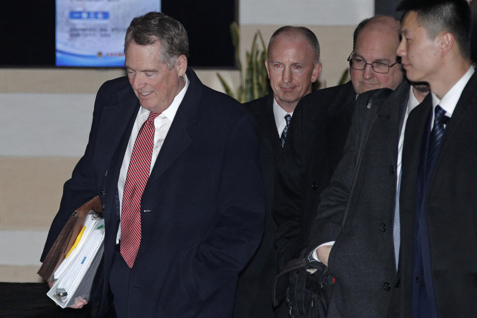 U.S. Trade Representative Robert Lighthizer, left, is followed by his deputy Jeffrey D. Gerrish, center, and delegations as they leave a hotel to attend a new round of high-level trade talks with Chinese officials in Beijing, Thursday, Feb. 14, 2019. (AP Photo/Andy Wong)