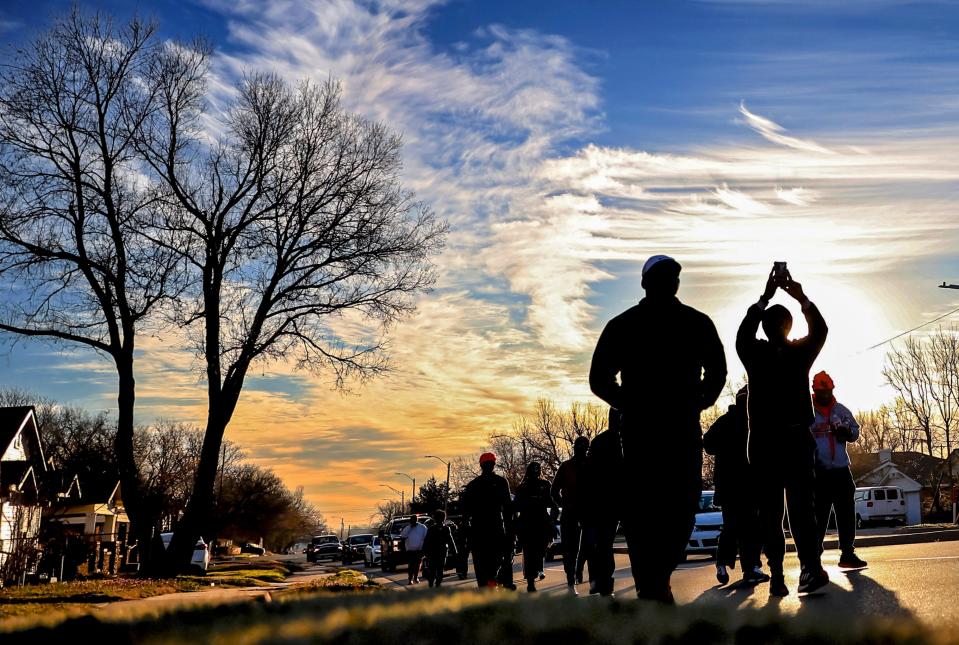 Community members march Wednesday through northeast Oklahoma City in protest of possible new jail sites on the northeast side of of the city.