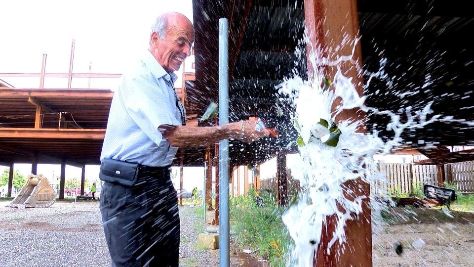 Seaside Heights Mayor Tony Vaz smashes a bottle of champagne on the steel structure on the Boulevard in Seaside Heights, between Hamilton and Webster Avenues, Monday morning, August 16, 2021.  The site has been an eyesore for more than a decade. It's slated to be replaced by 79 residential units, a restaurant and retail stores on the bottom floors.