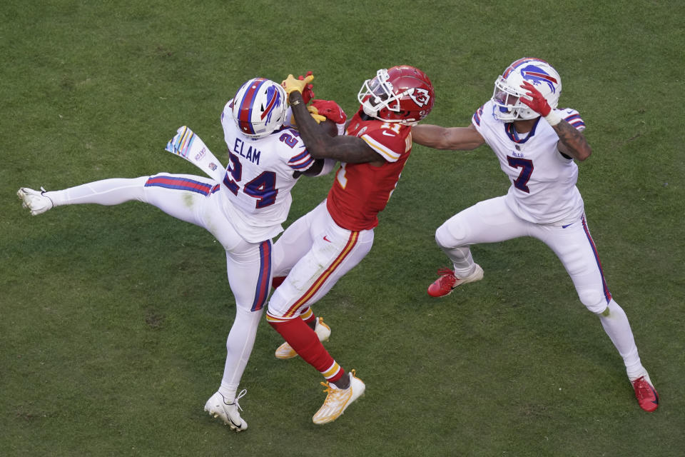Kansas City Chiefs wide receiver Marquez Valdes-Scantling (11) reaches for a pass as Buffalo Bills cornerback Kaiir Elam (24) and cornerback Taron Johnson (7) defend during the first half of an NFL football game Sunday, Oct. 16, 2022, in Kansas City, Mo. (AP Photo/Charlie Riedel)